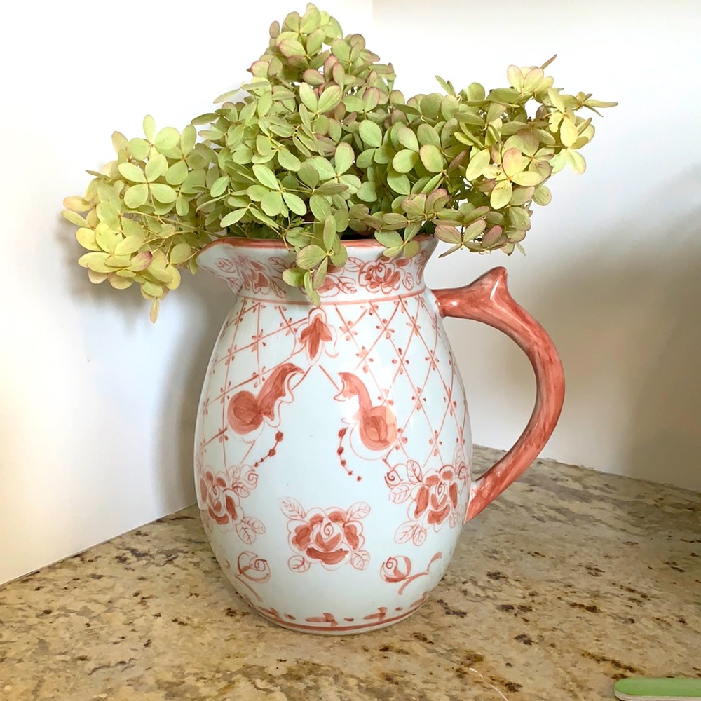 Coral and white ceramic pitcher